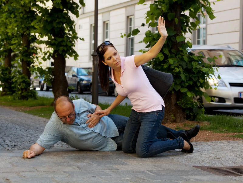 Man collapsed with chest pain, woman calling for help.