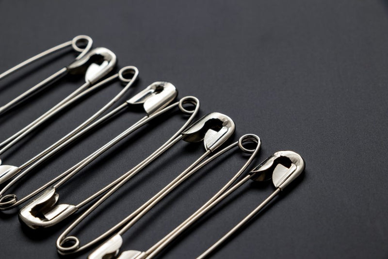 Shiny metal safety pins.