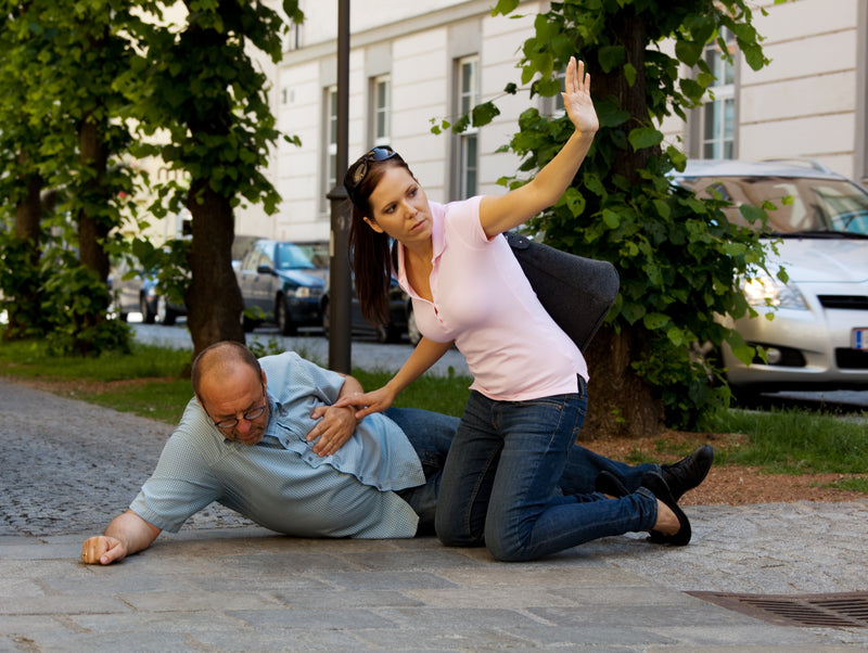 Man collapsed with chest pain, woman calling for help.