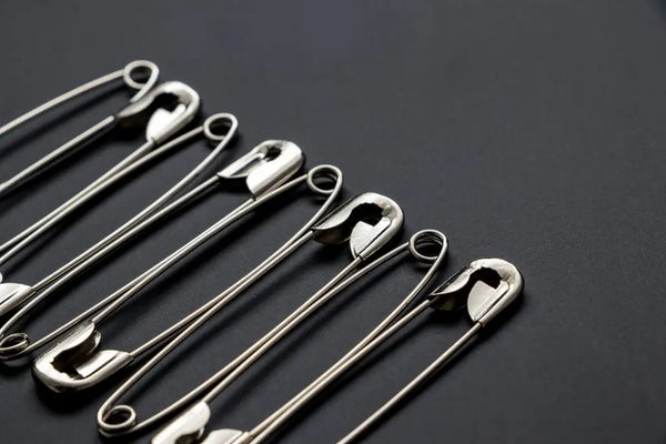 Shiny metal safety pins.