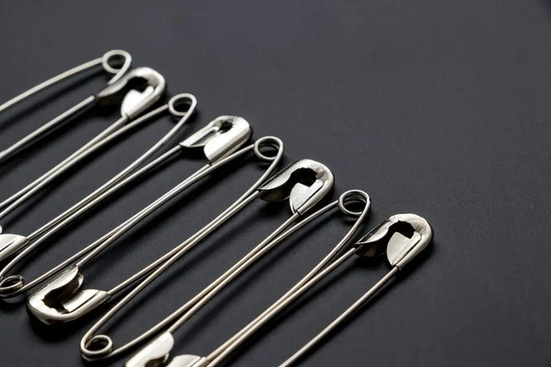 Shiny metal safety pins.