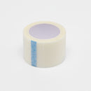 Medical tape roll with blue stripe.